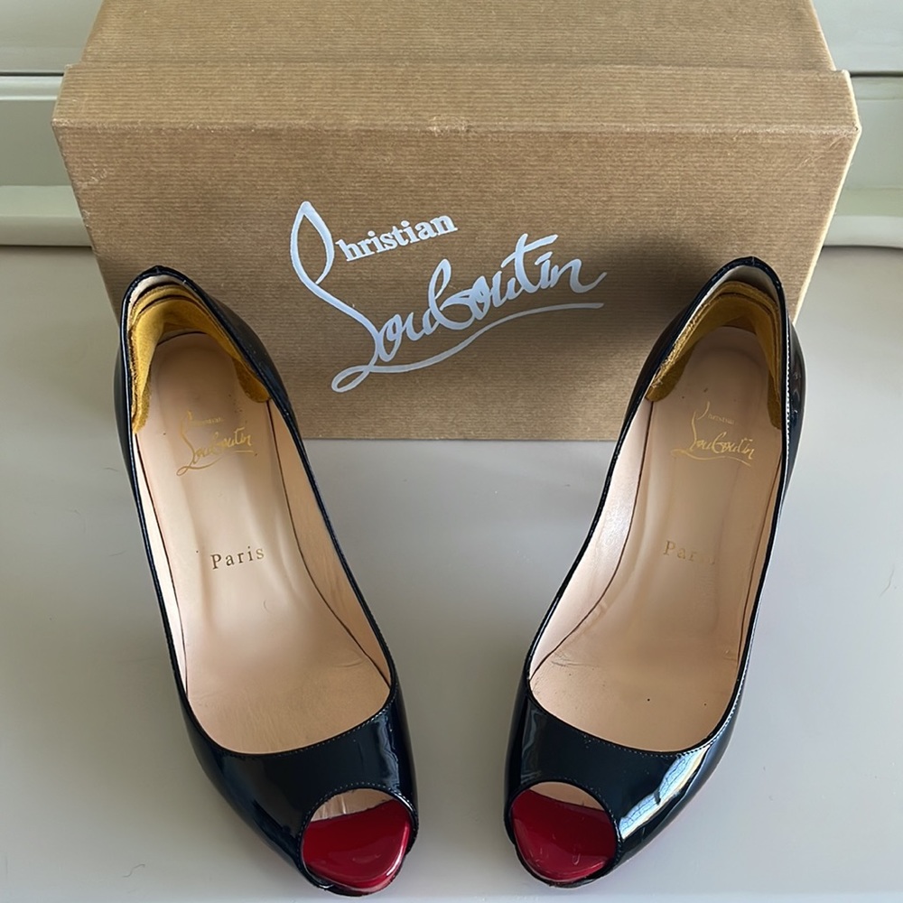 Black with red peep toe Christian Loubution kitten heels. Size 37